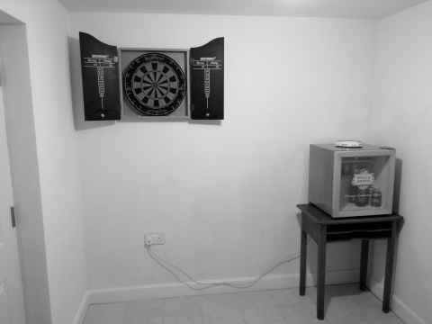 The newly painted study, view from the door showing dartboard and beer fridge