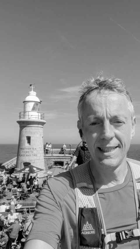 Me in front of the lighthouse champagne bar on Folkestone's Harbour Arm. A mid-run selfie.