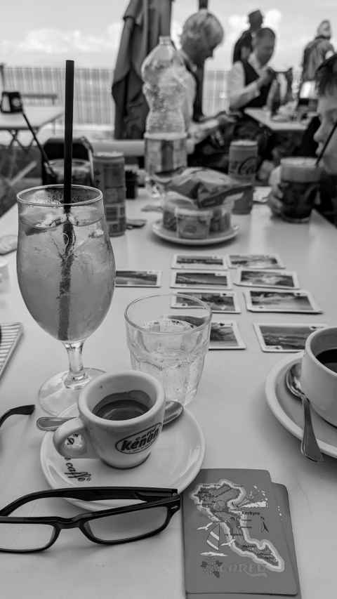 Picture of our holiday table, with drinks and playing cards, and in theory a view of Mount Vesuvius in the background