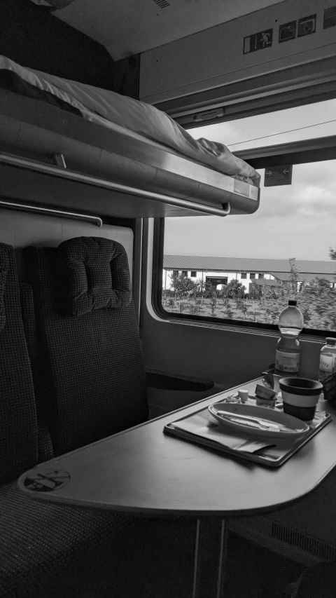 the inside of my sleeper cabin again, with the bunk folded down, and my breakfast things still present