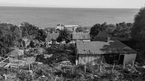 Looking down over a partly demolished property known as Three Bears Cottage