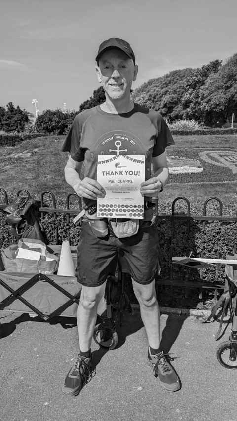 Me at parkrun with my volunteer certificate