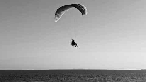 Paramotor flying along the beach in Sandgat