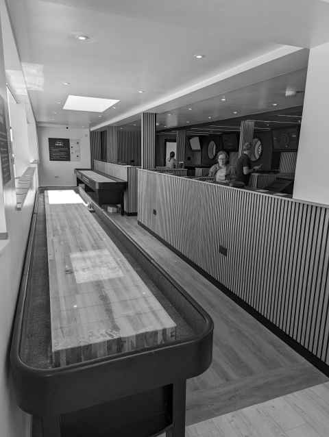 Shuffleboard and darts in The Boardroom