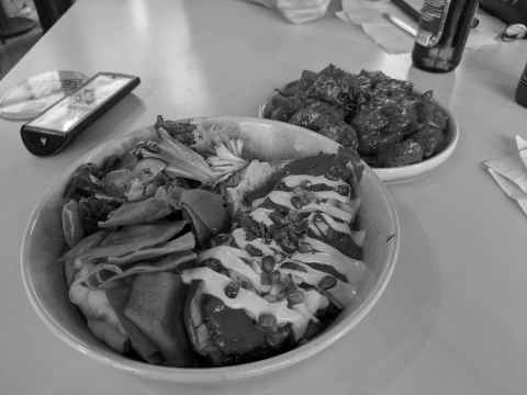 Aubergine plate and a side of potatoes from the Syrian place in Seven Dials