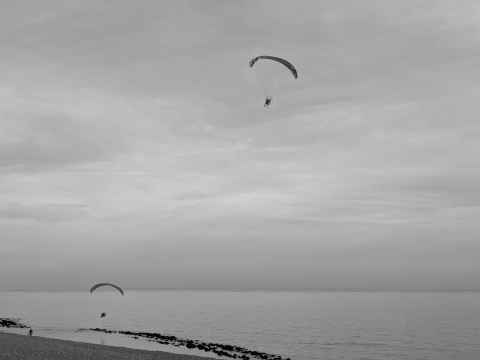 Two parasenders along the beach at Seabrook
